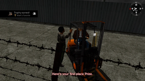 Mark handing the first prize trophy to Ryo for winning the forklift race.